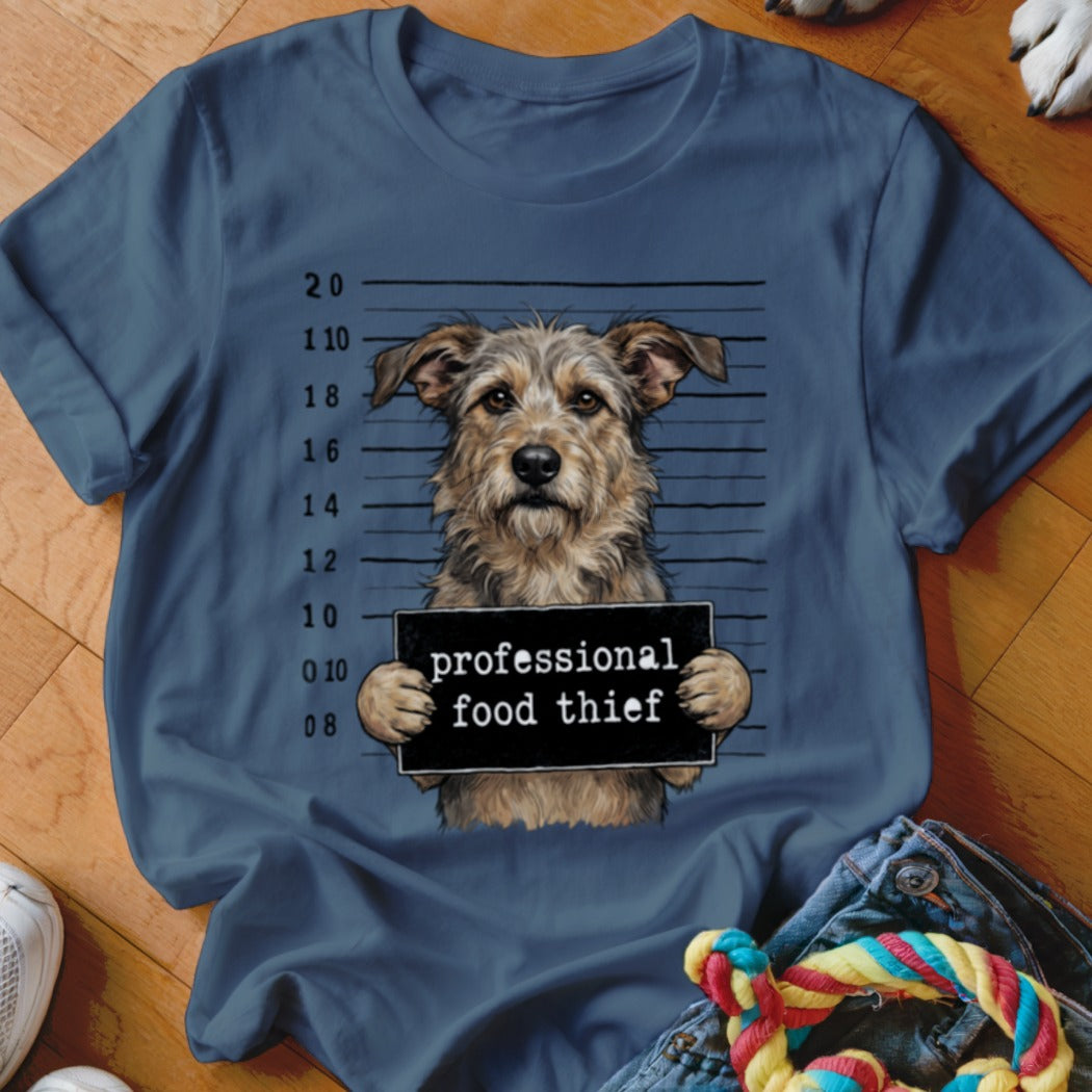 Shaggy dog in mugshot, holding sign reading "professional food thief."