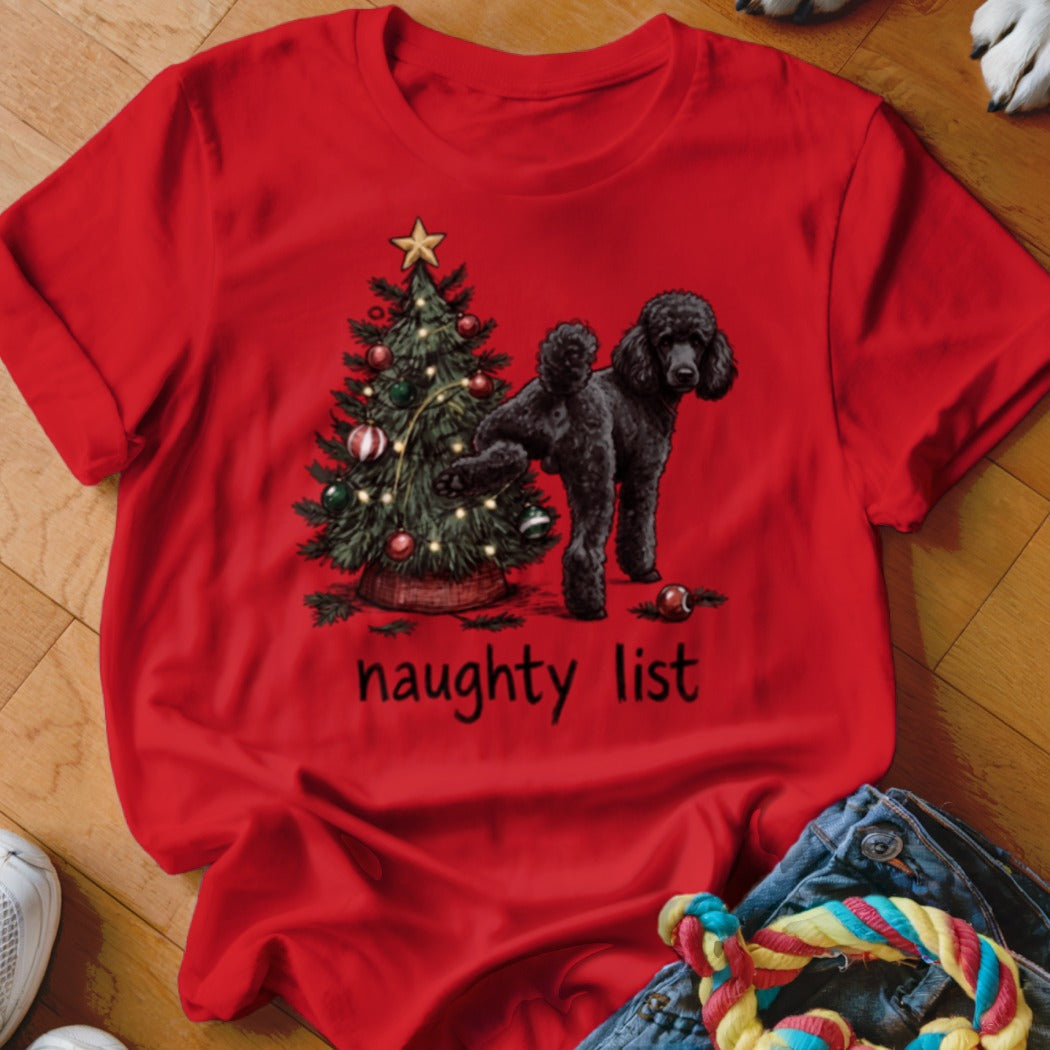 Red t-shirt with a black poodle standing next to a Christmas tree, with the text "naughty list".