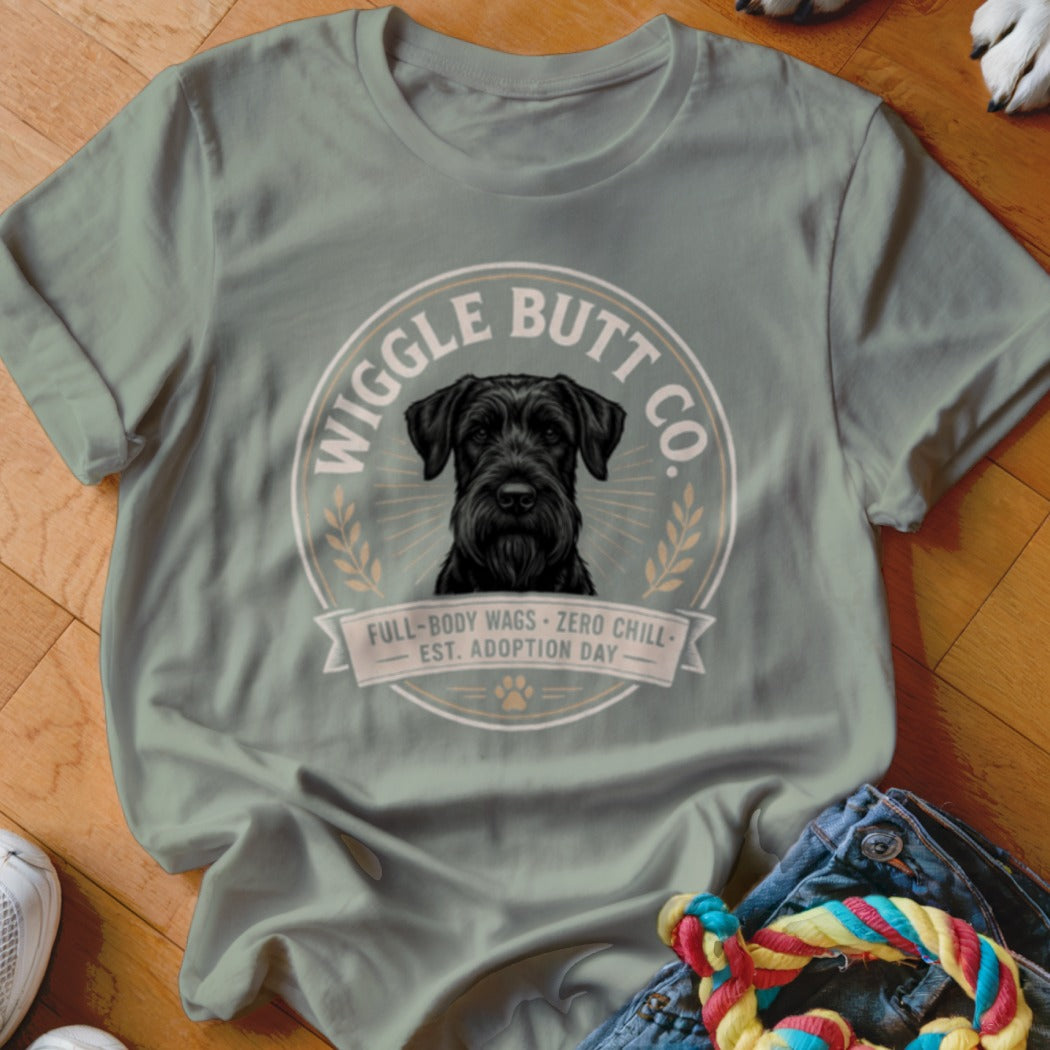 Sage t-shirt with a black schnauzer portrait and text: Wiggle Butt Co., Full-Body Wags, Zero Chill, Est. Adoption Day.