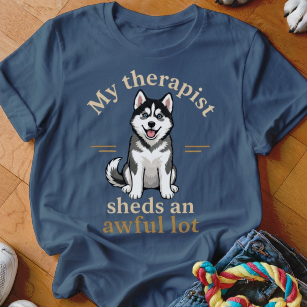 Blue t-shirt with illustration of husky and text "My therapist sheds an awful lot".