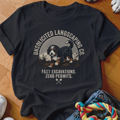 T-shirt graphic: Bernese Mountain Dog, text "UNSOLICITED LANDSCAPING CO. FAST EXCAVATIONS. ZERO PERMITS."