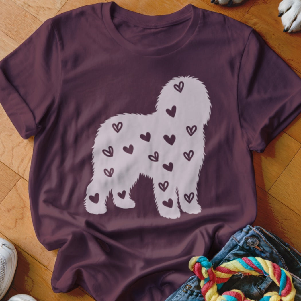 Maroon t-shirt with white silhouette of shaggy dog covered in small dark hearts.