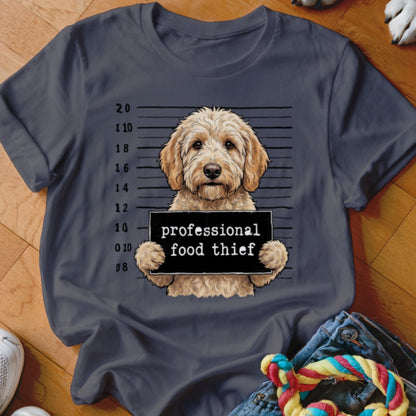Goldendoodle dog mugshot with "professional food thief" sign.