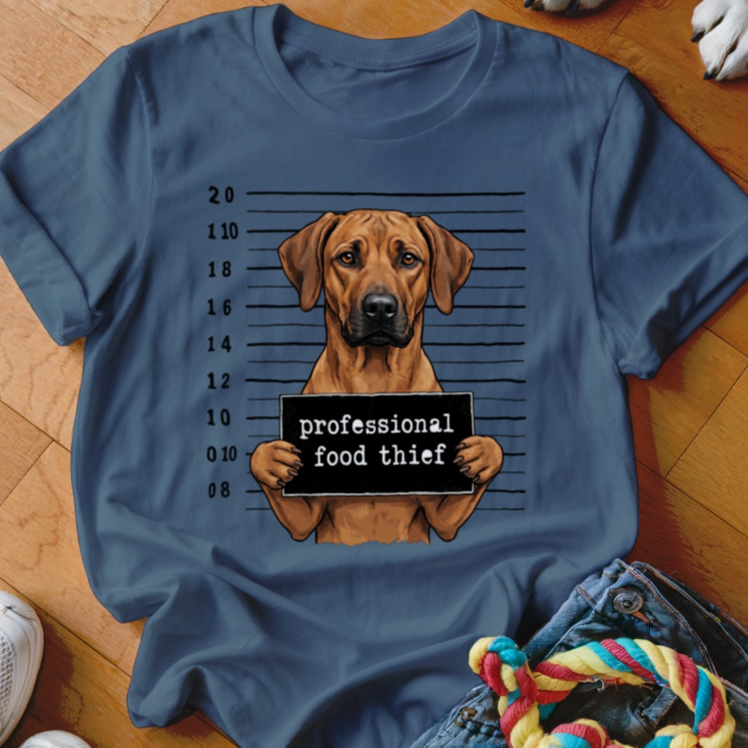 Ridgeless Rhodesian Ridgeback dog mugshot with "professional food thief" sign.