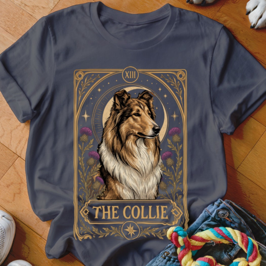 A dark gray t-shirt featuring a tarot card design with a collie dog, a crescent moon, and the text THE COLLIE.