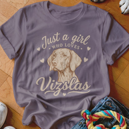 A purple t-shirt featuring a Vizsla illustration and the text "Just a girl who loves Vizslas".