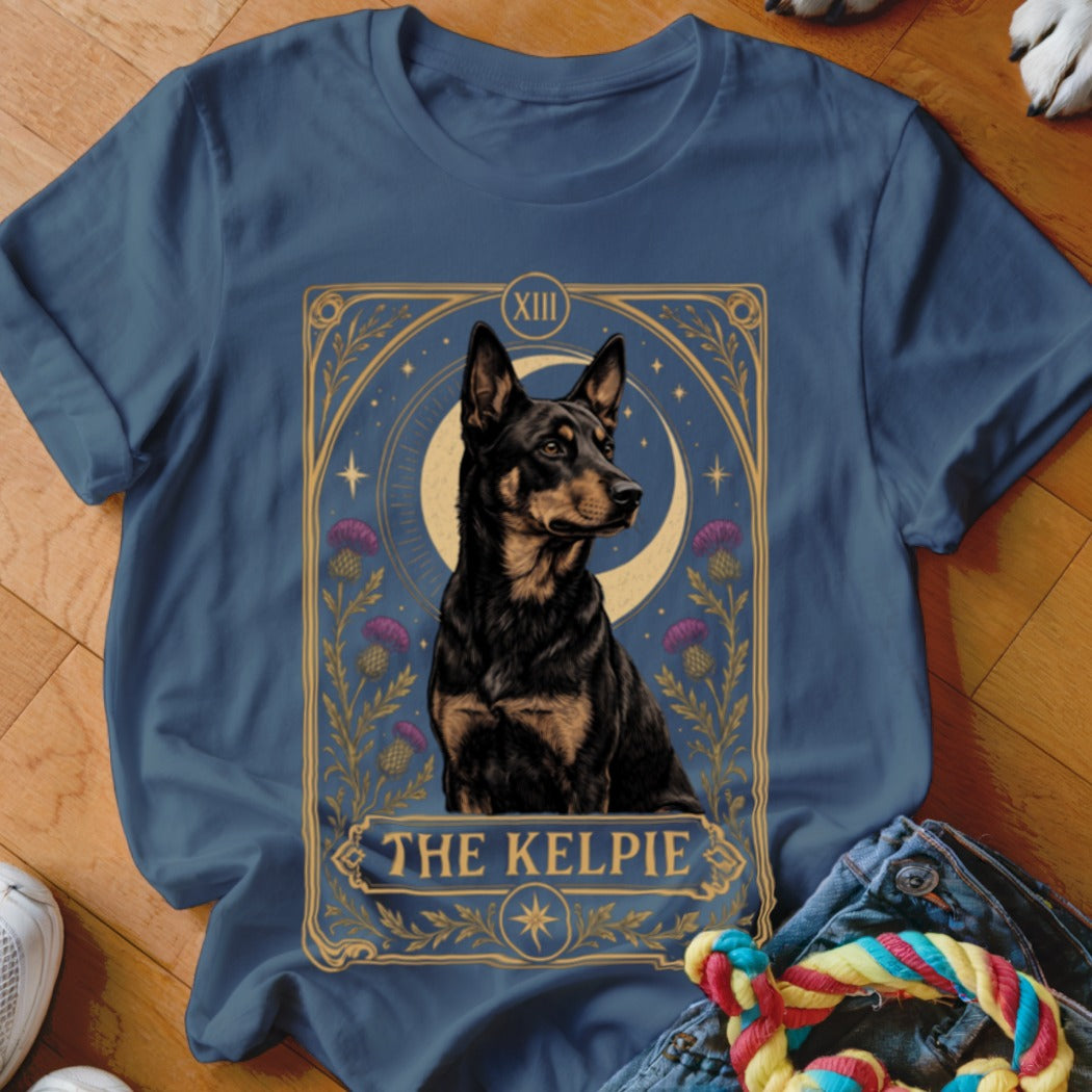 A dark blue crewneck t-shirt featuring a tarot card graphic of a black and tan Kelpie dog with the text THE KELPIE.