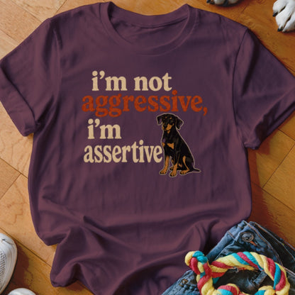 Maroon t-shirt with text "i'm not aggressive, i'm assertive" and a dog graphic.