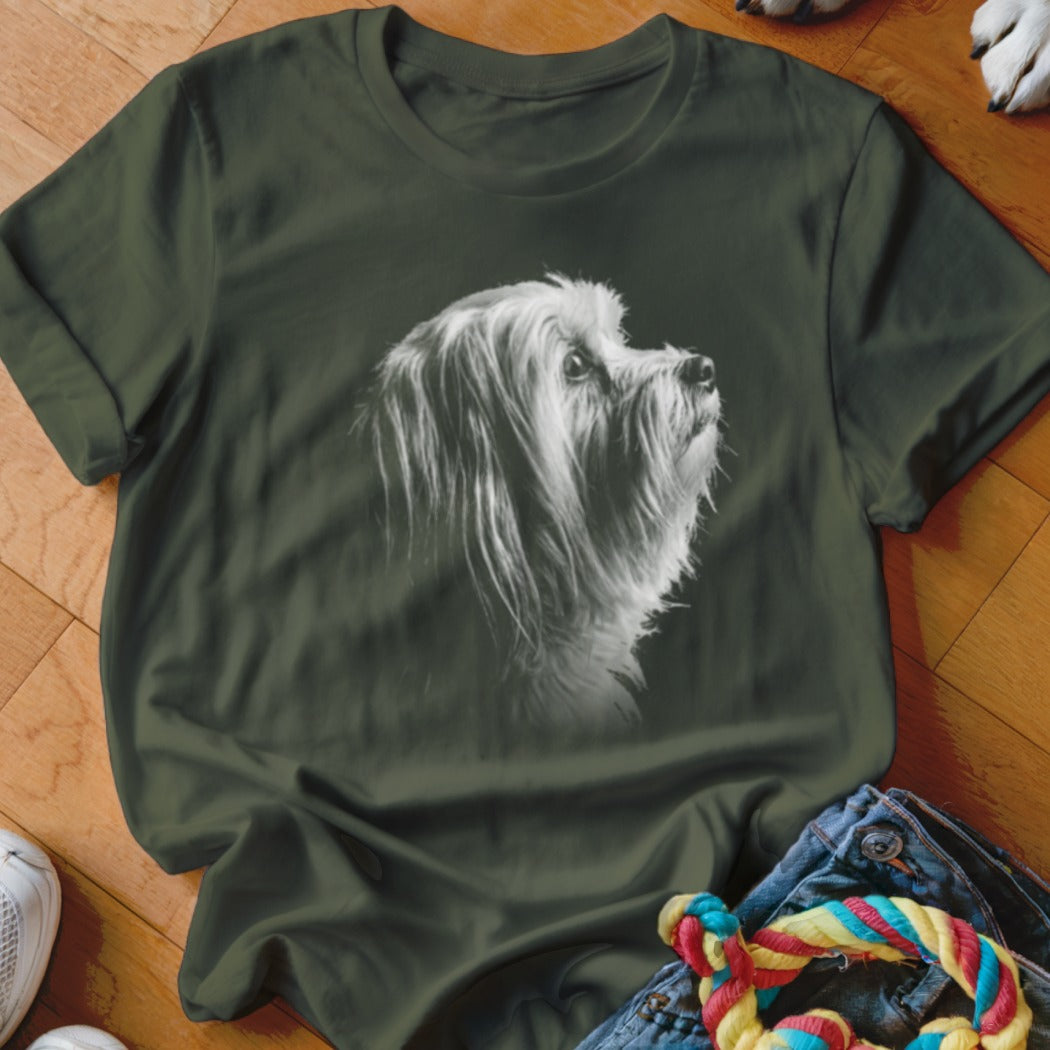 Green t-shirt featuring a black and white portrait of a fluffy dog looking upwards.