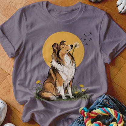 A purple t-shirt featuring a graphic of a collie dog blowing a dandelion seed head.