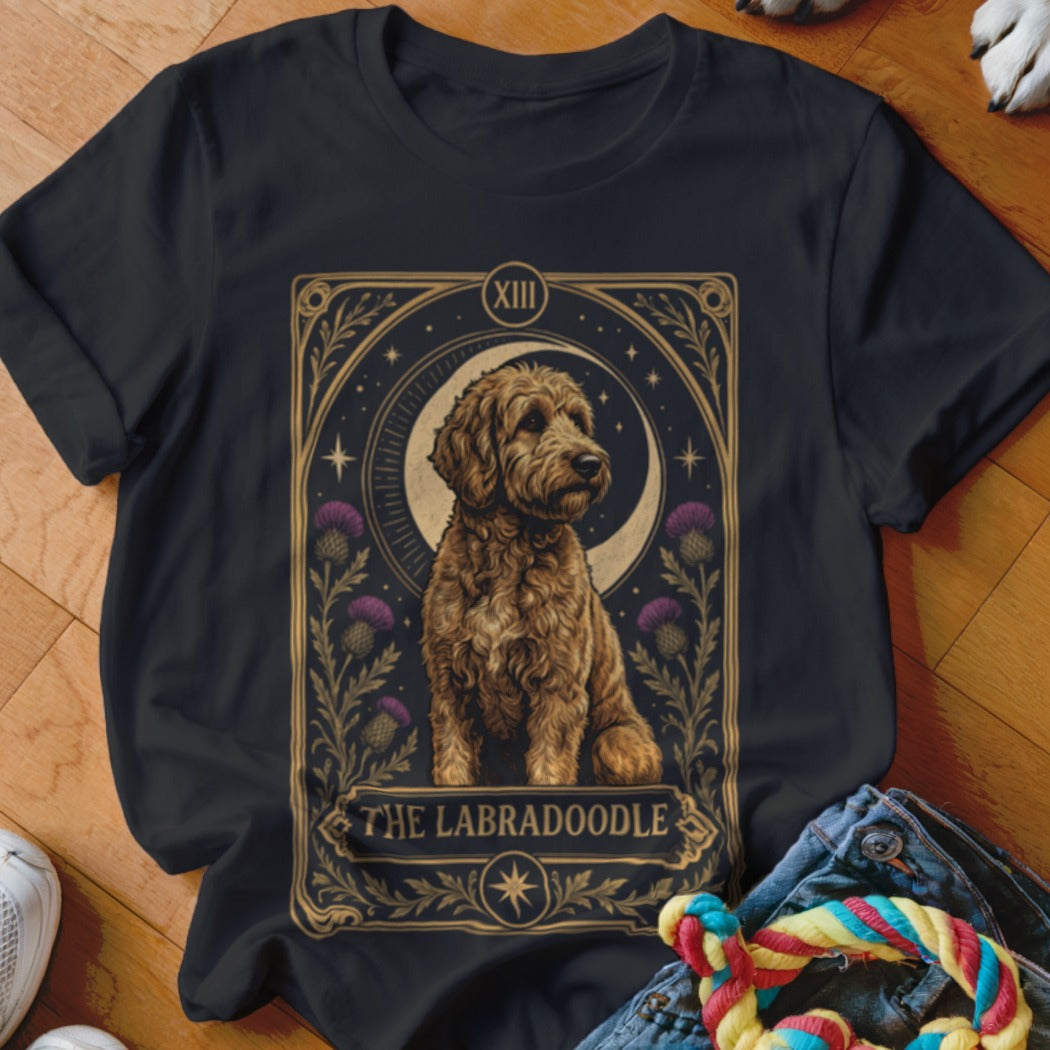 Black t-shirt featuring a tarot card style graphic of a golden Labradoodle with moon and thistle details.