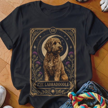 Black t-shirt featuring a tarot card style graphic of a golden Labradoodle with moon and thistle details.