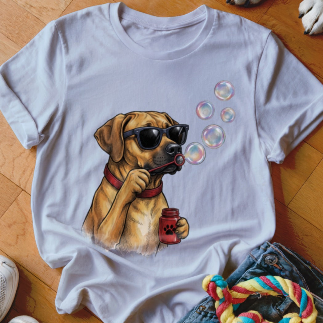 A white t-shirt featuring an illustration of a brown dog wearing sunglasses and blowing bubbles.