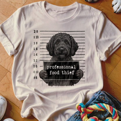 Black dog mugshot with "professional food thief" sign and height chart.