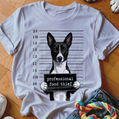 Dog wearing a mugshot sign that reads "professional food thief."