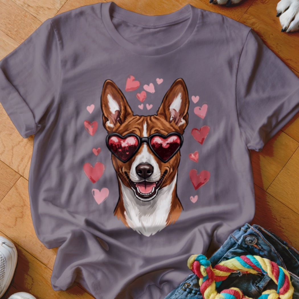 A grey t-shirt featuring a graphic of a brown and white dog wearing heart-shaped sunglasses surrounded by floating pink hearts.