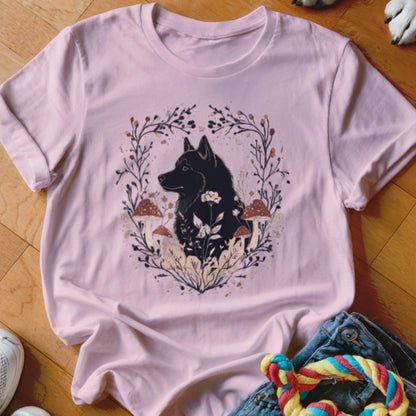 Light pink crewneck t-shirt featuring a graphic of a black dog surrounded by mushrooms and foliage.