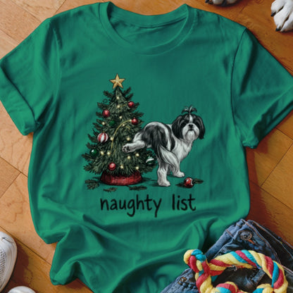 A green t-shirt with a graphic of a black and white dog peeing on a Christmas tree, with the text "naughty list" below.