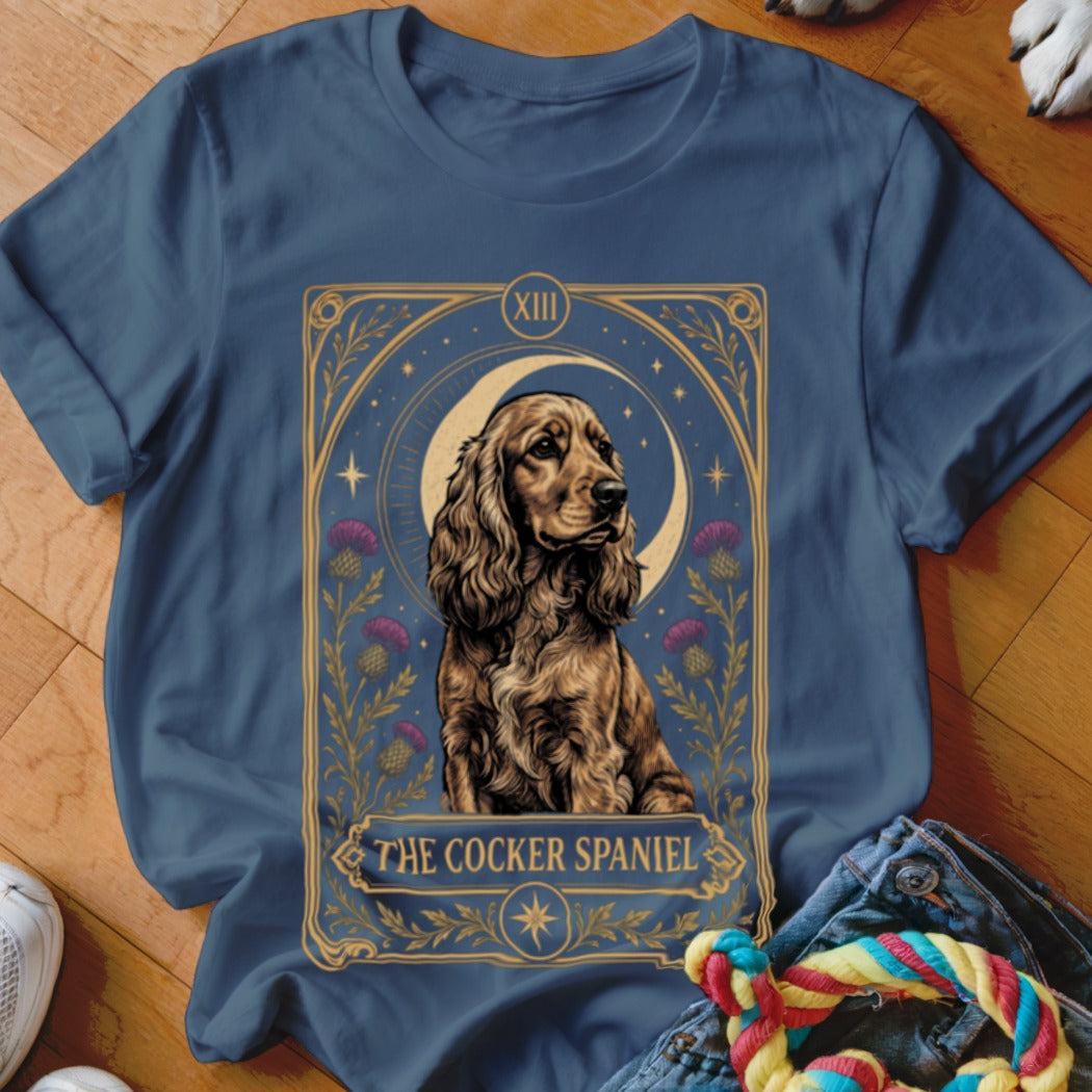A dark blue crewneck t-shirt featuring a tarot card style Cocker Spaniel graphic.