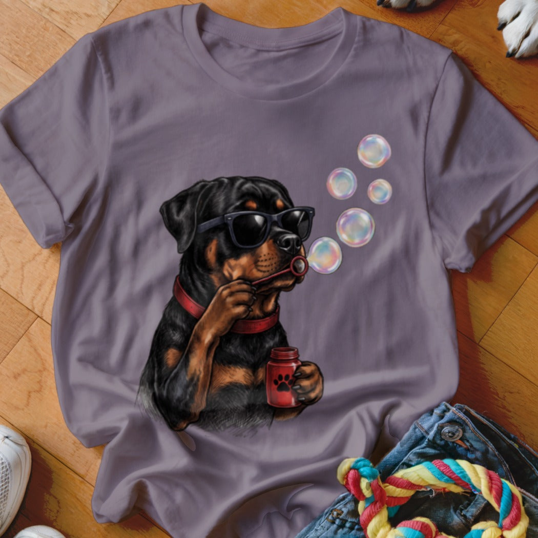 Purple crewneck t-shirt featuring a graphic of a Rottweiler wearing sunglasses and blowing soap bubbles.