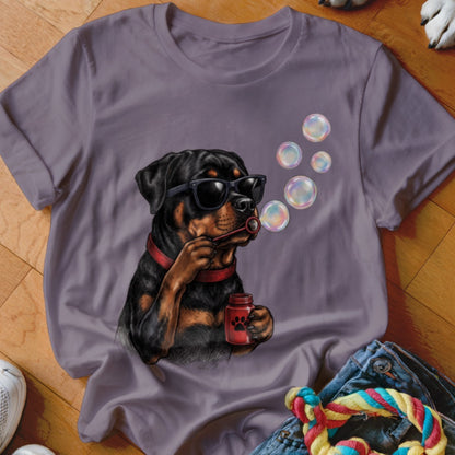 Purple crewneck t-shirt featuring a graphic of a Rottweiler wearing sunglasses and blowing soap bubbles.