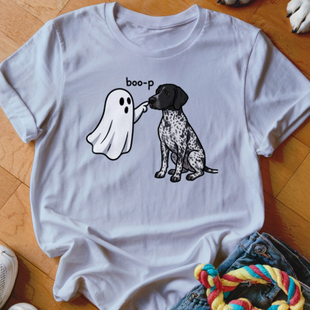 White t-shirt featuring a ghost character saying "boo-p" to a black and white spotted dog.