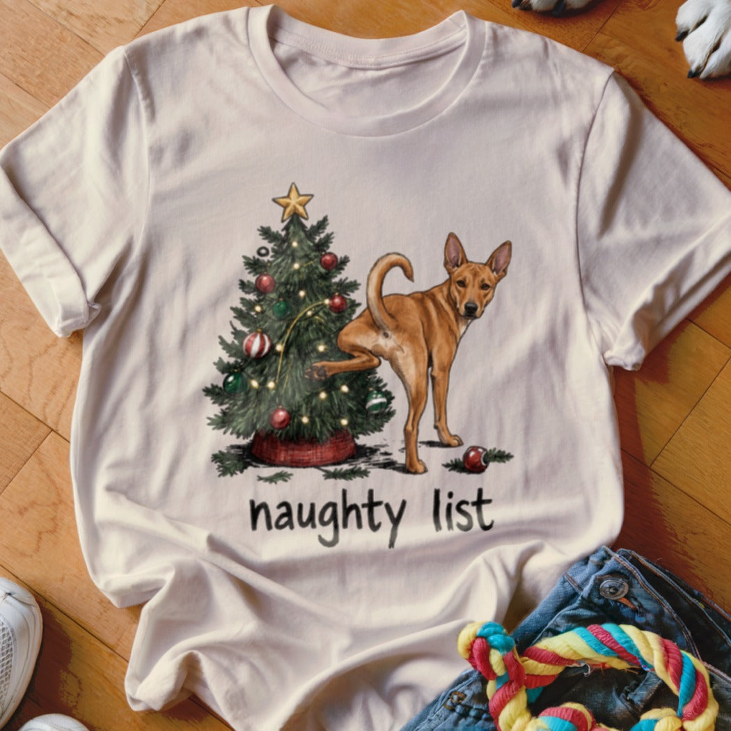 T-shirt with a dog beside a Christmas tree and the text "naughty list".