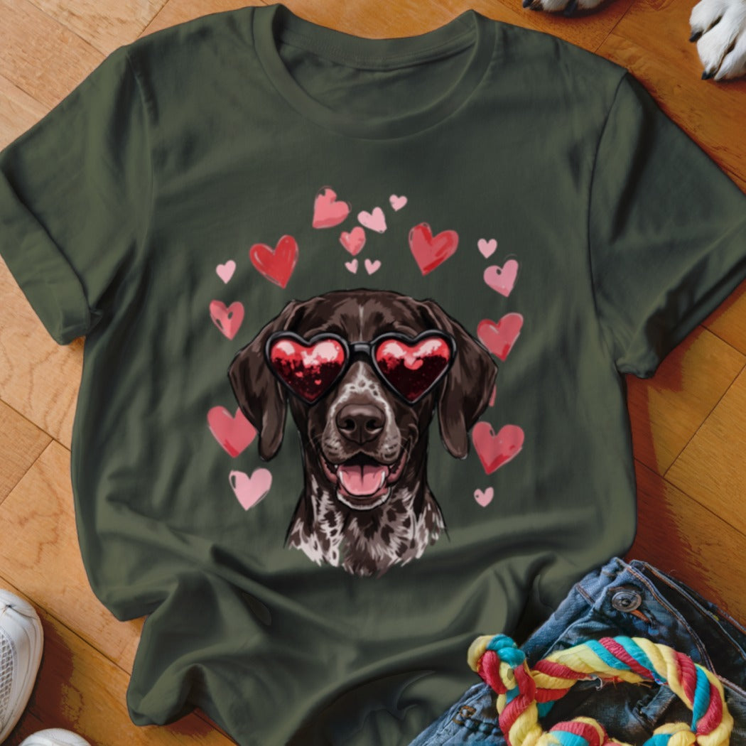 Dark green crewneck t-shirt featuring a graphic of a brown dog wearing heart-shaped sunglasses surrounded by pink hearts.