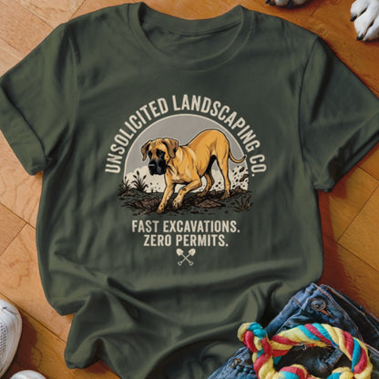 Green t-shirt with a tan dog and text "UNSOLICITED LANDSCAPING CO. FAST EXCAVATIONS. ZERO PERMITS."