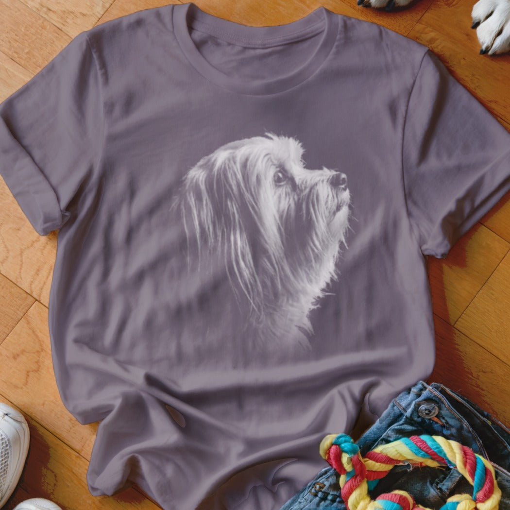 T-shirt with a white sketch of a shaggy dog looking upwards on a purple background.