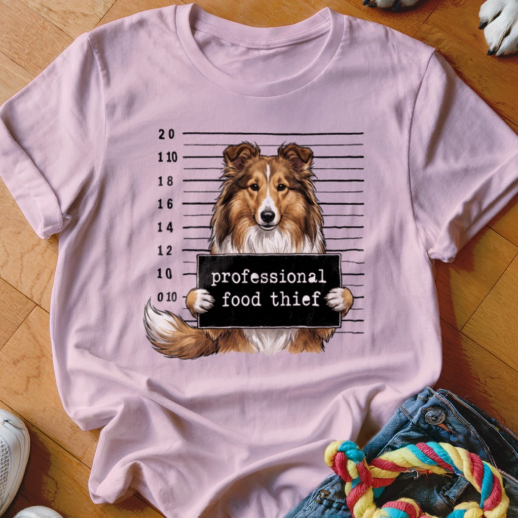 Pink t-shirt with a dog in a police lineup holding a "professional food thief" sign.
