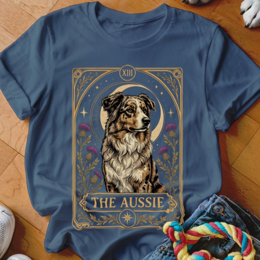 Blue t-shirt featuring a tarot-style graphic of an Australian Shepherd with purple flowers and a crescent moon.