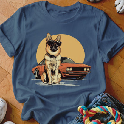German Shepherd wearing sunglasses sitting in front of an orange car and yellow sun.