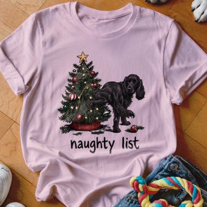 Pink t-shirt with a black dog, Christmas tree, and "naughty list" text.