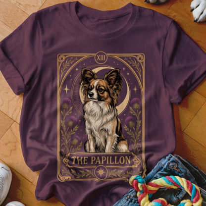 A dark purple crewneck t-shirt featuring a tarot card style illustration of a Papillon dog.