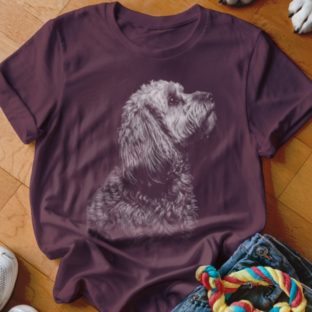 T-shirt with a sketched portrait of a fluffy dog looking up.