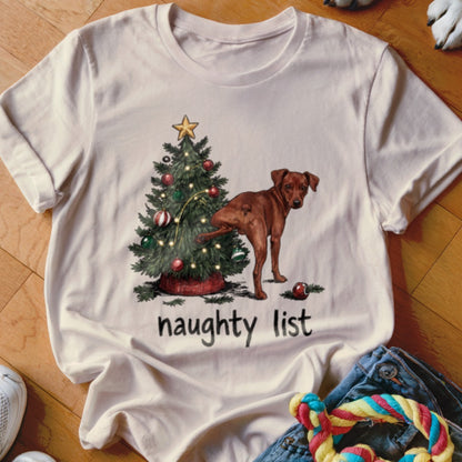 T-shirt with a brown dog near a Christmas tree and the words "naughty list".