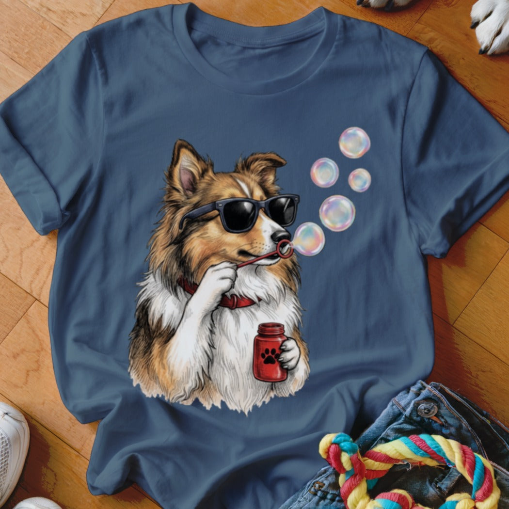 Blue t-shirt featuring an illustrated dog wearing sunglasses and blowing bubbles.