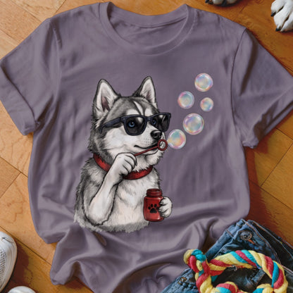 Grey t-shirt featuring an illustration of a husky wearing sunglasses and blowing soap bubbles.