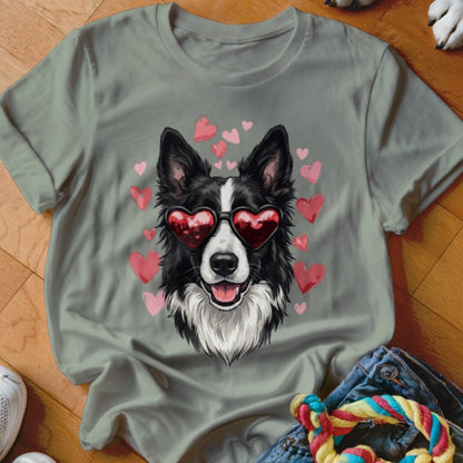A gray t-shirt featuring a graphic of a black and white dog wearing heart-shaped sunglasses, surrounded by pink hearts.