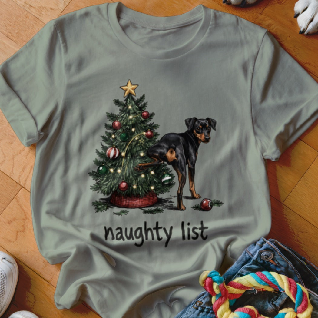 Black and tan dog by Christmas tree with "naughty list" text.