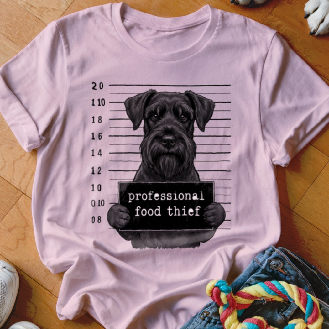 Pink t-shirt with a black schnauzer mugshot holding a sign that says "professional food thief".