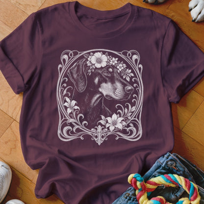 T-shirt with a black dog wearing a floral crown in a decorative frame.