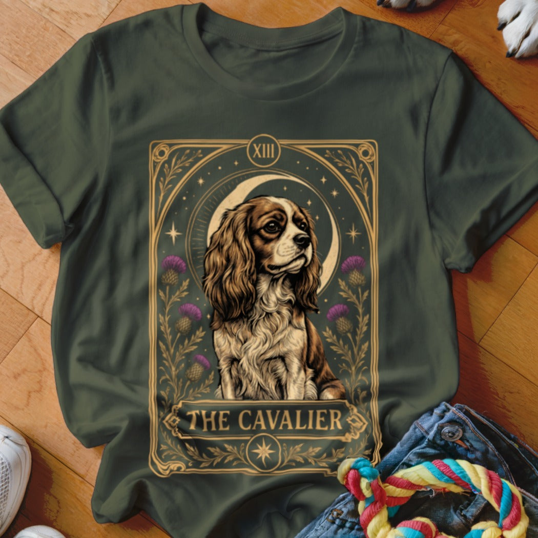 Dark green t-shirt featuring a tarot card style graphic of a Cavalier King Charles Spaniel with text reading THE CAVALIER.