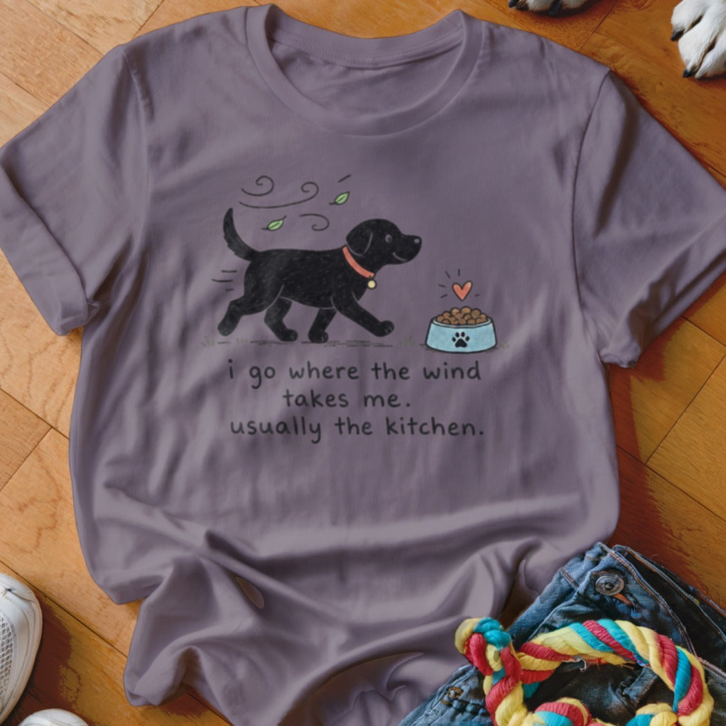 T-shirt with black lab illustration and text "i go where the wind takes me. usually the kitchen."