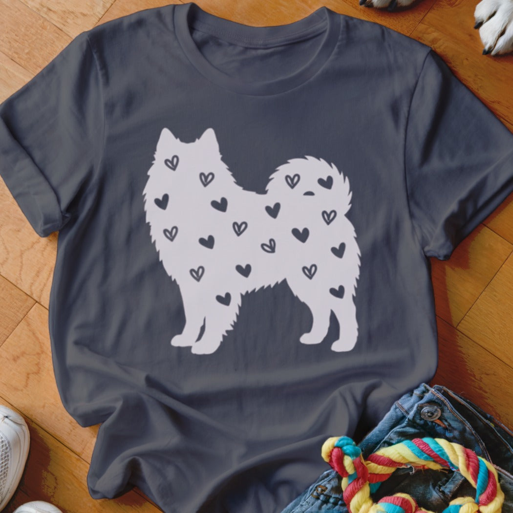 Dark t-shirt with a white silhouette of a dog filled with small black hearts.