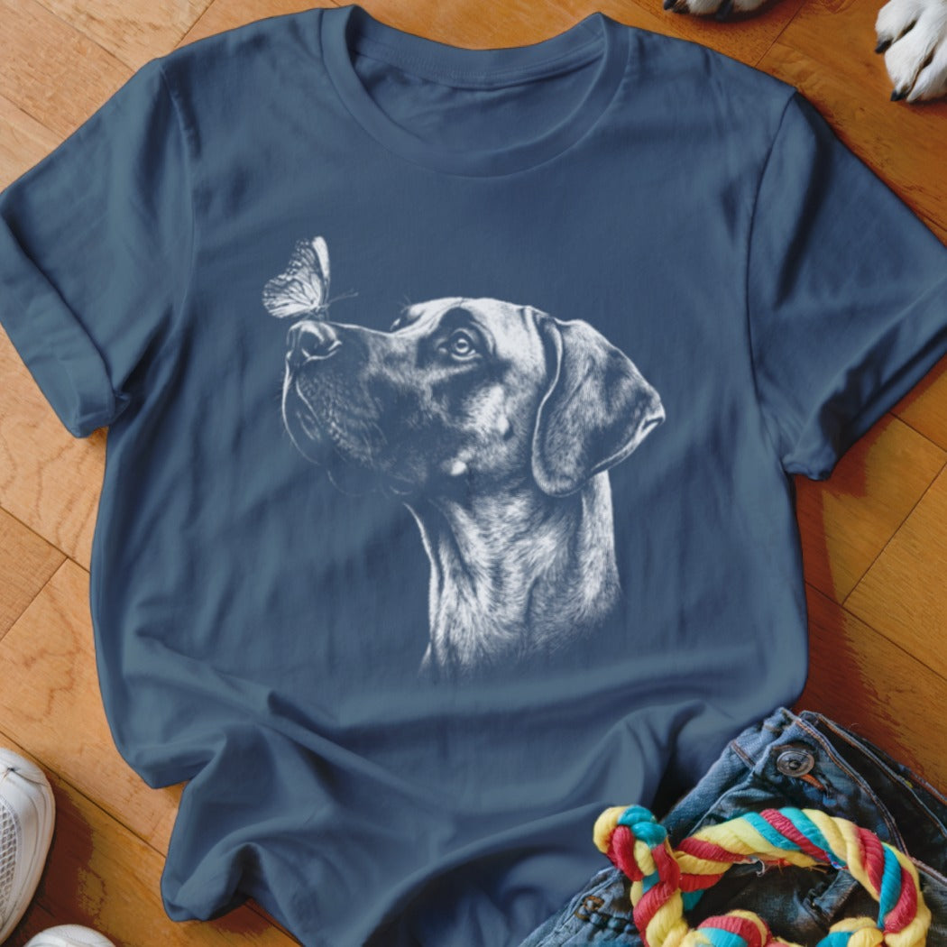 Navy blue t-shirt featuring a white sketch graphic of a dog looking up at a butterfly.