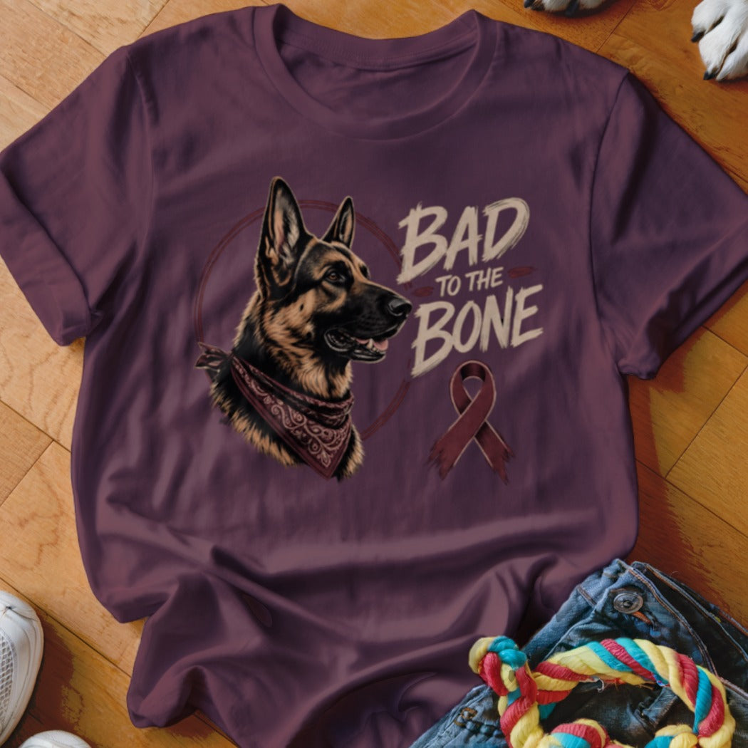 German Shepherd wearing bandana with text "Bad to the Bone" and a ribbon.