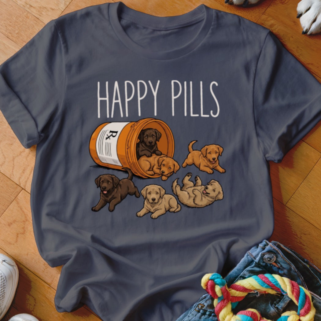 Dark t-shirt with "HAPPY PILLS" text and illustration of puppies spilling from a prescription bottle.