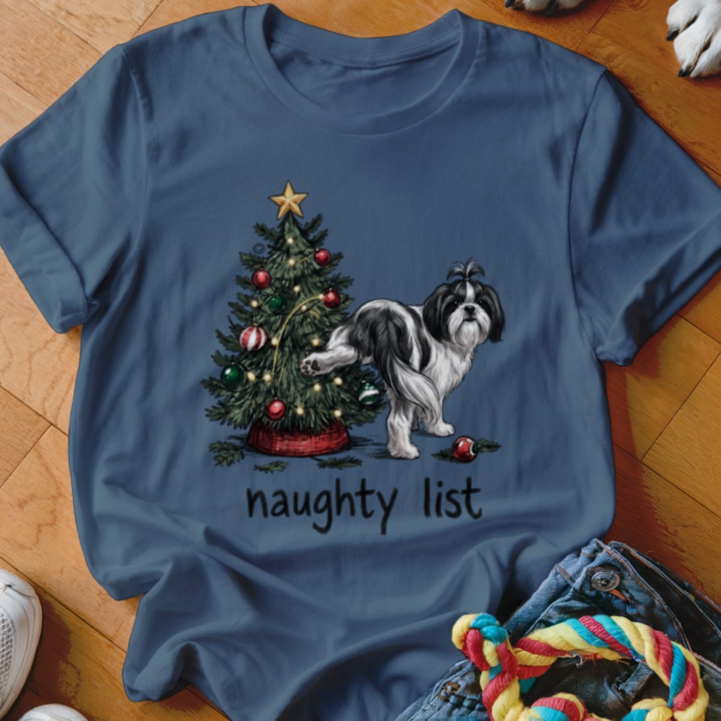 Blue crewneck t-shirt featuring a graphic of a black and white dog lifting its leg against a decorated Christmas tree with the text "naughty list" below.